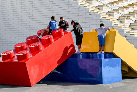 Giant Lego bricks with kids climbing up on them, in front of the LEGO House, Billund, Denmark